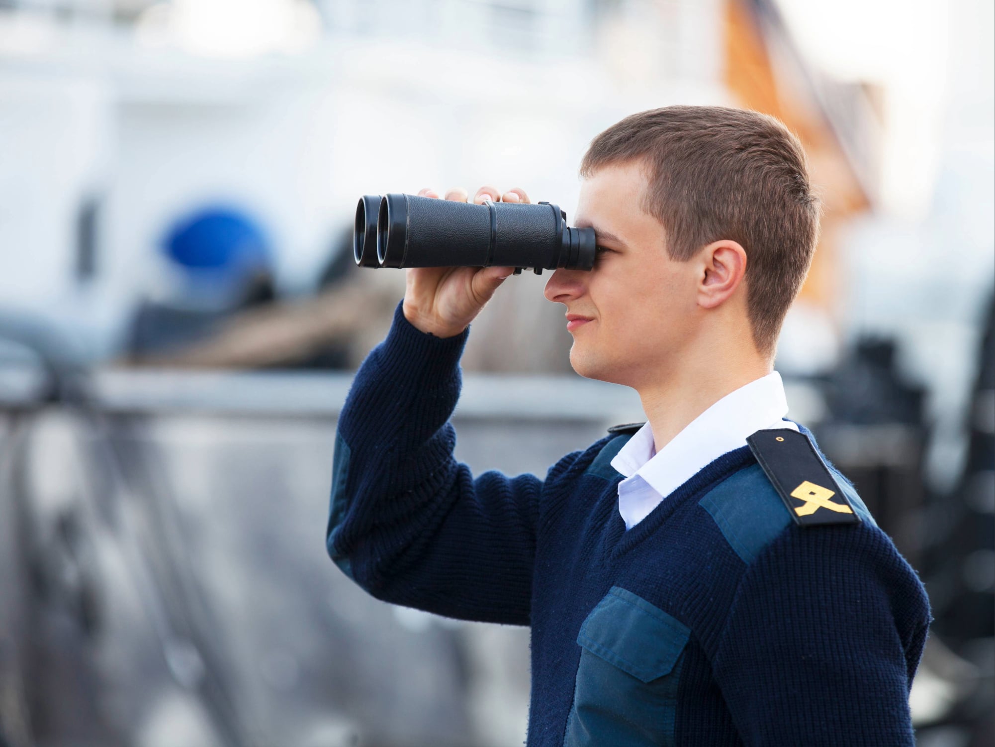 Cadet apprentice gaining hands-on maritime training on the deck of a North Sea Shipping vessel.